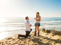 Man proposing to woman on beach