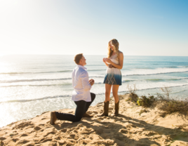 Man proposing to woman on beach