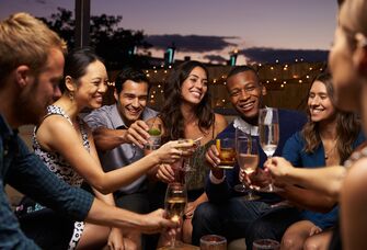 A group of friends toasting at engagement party.