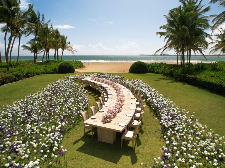 Outdoor beach wedding with serpent table and wildflowers