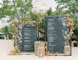 black and white seating chart with bright floral border