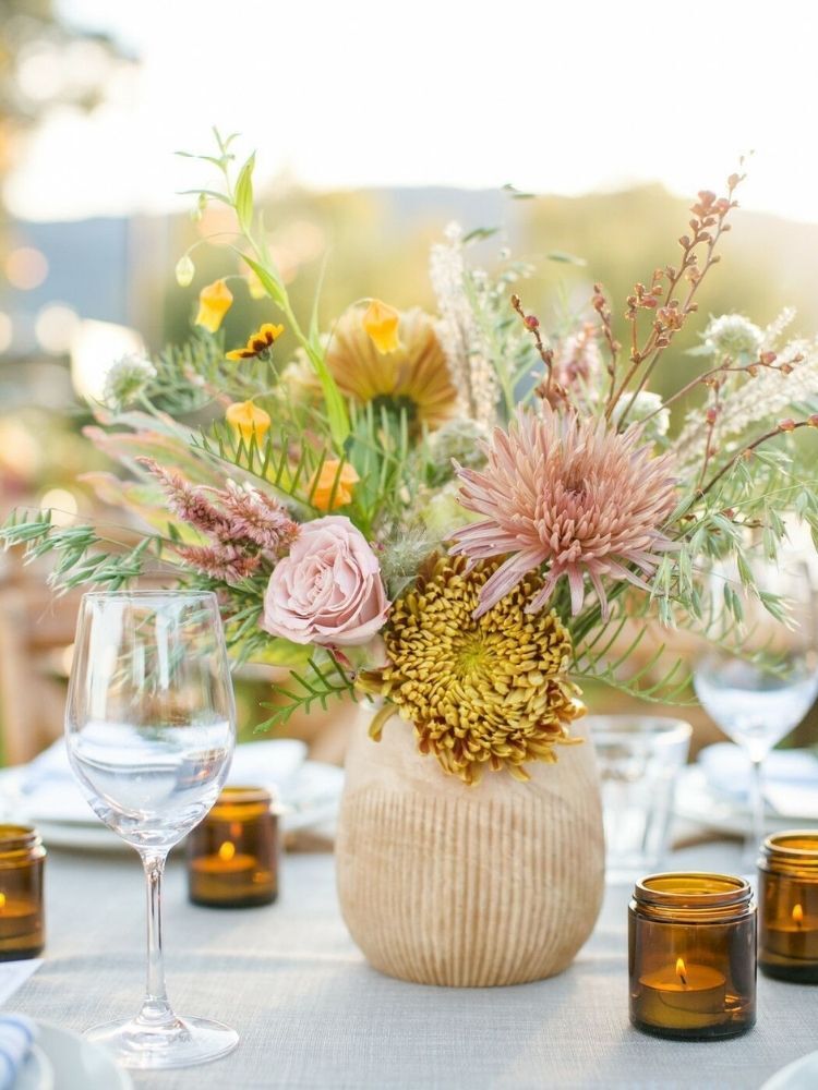 yellow chrysanthemum arrangement in beige vase