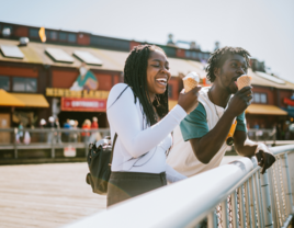 Couple enjoying ice cream on date at Seattle pier