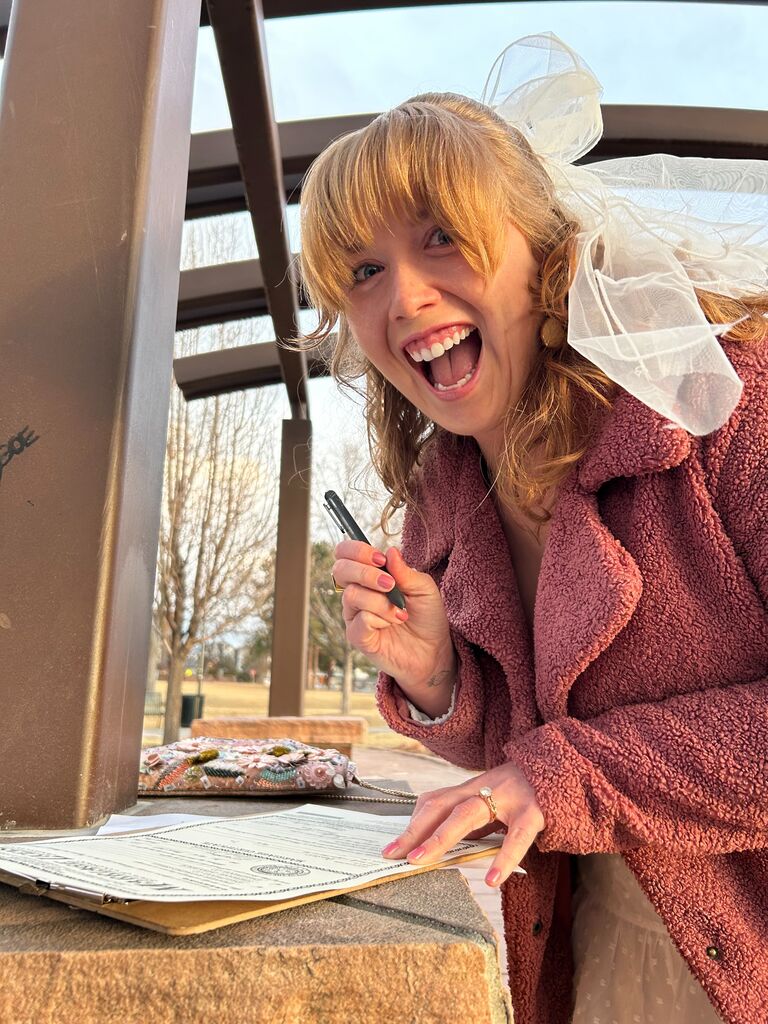 Steph happily signing a life altering legal document!