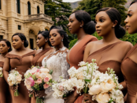 Group of bridesmaids posing with bride on wedding day