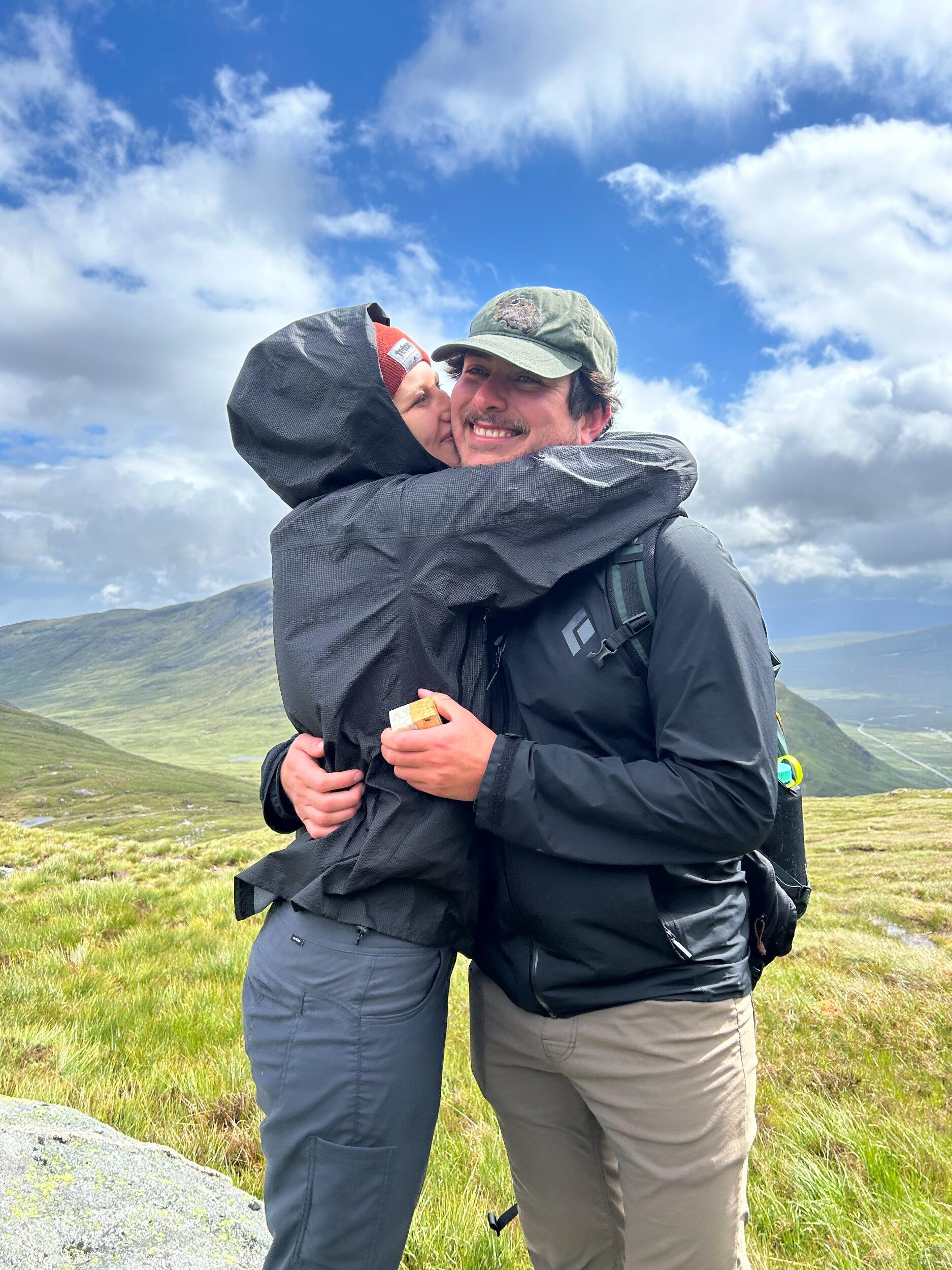 And on that trip, Devon proposed to Sophia in the Scottish Highlands, with the sun coming out after a hike of intense rain, roaring winds, and very wet clothes. The rest of the trip was spent as fiances!