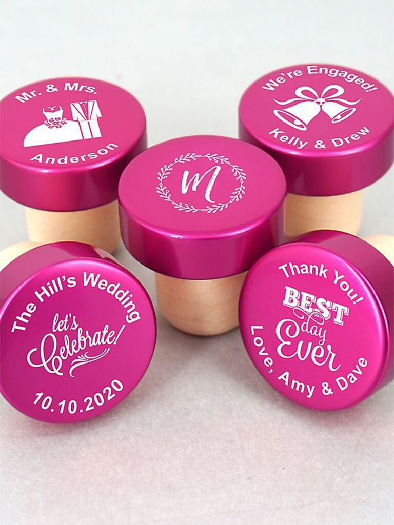 Custom pink bottle stopper with messages like 'Let's celebrate!' in white type