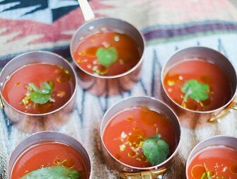 Wedding reception appetizer of mini gazpacho soups