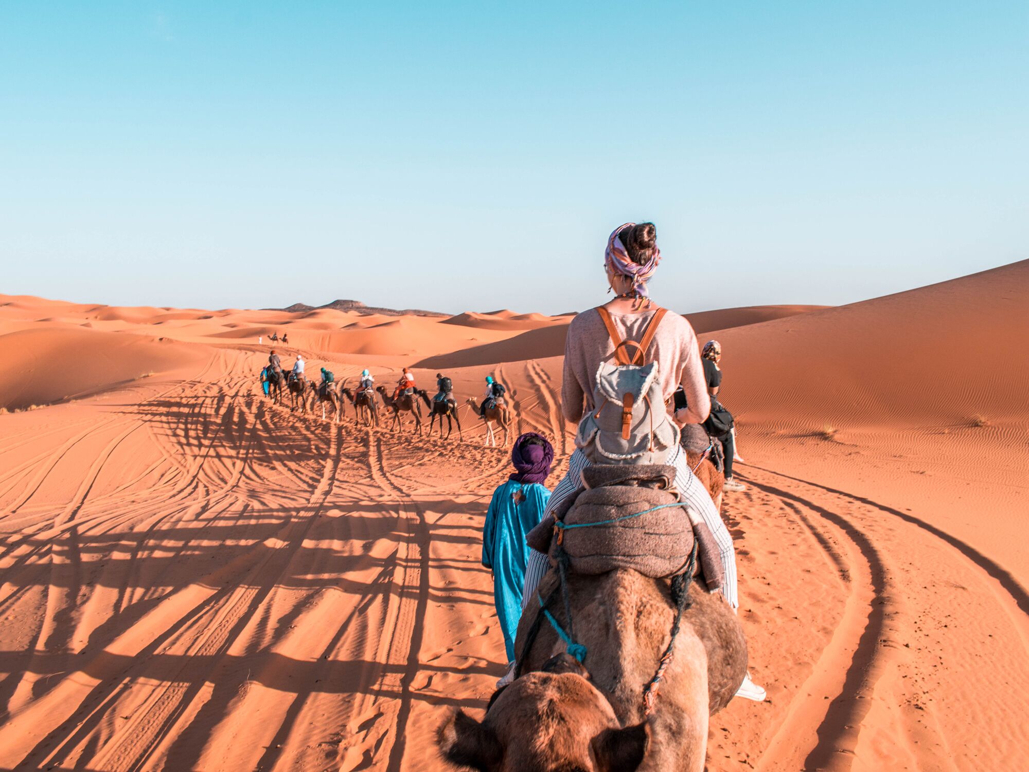 Person riding a camel in Sahara Desert Morocco during a camel expedition