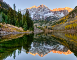 Sunrise hits snow dusted peaks of Maroon Bells in Aspen, Colorado