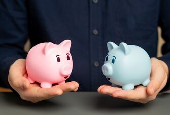 Man holding a pink and blue piggy bank