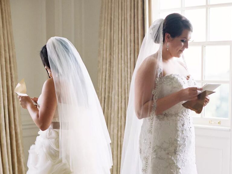 Two brides read love letters from one another on their wedding day.