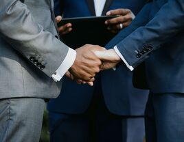 Couple holding hands during wedding ceremony.