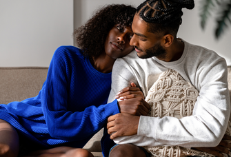 Woman laying head on man's shoulder