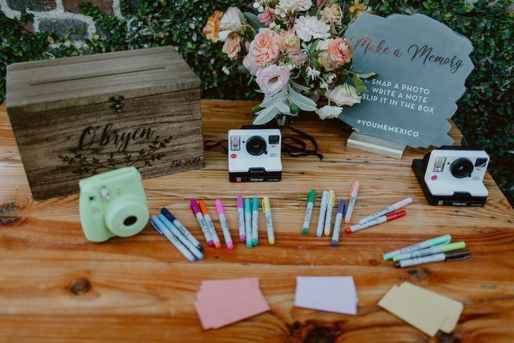 Table with pens and Polaroid cameras