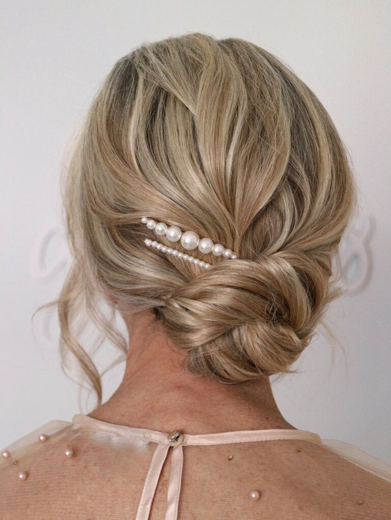 Low bun with pearls wedding updo for long hair
