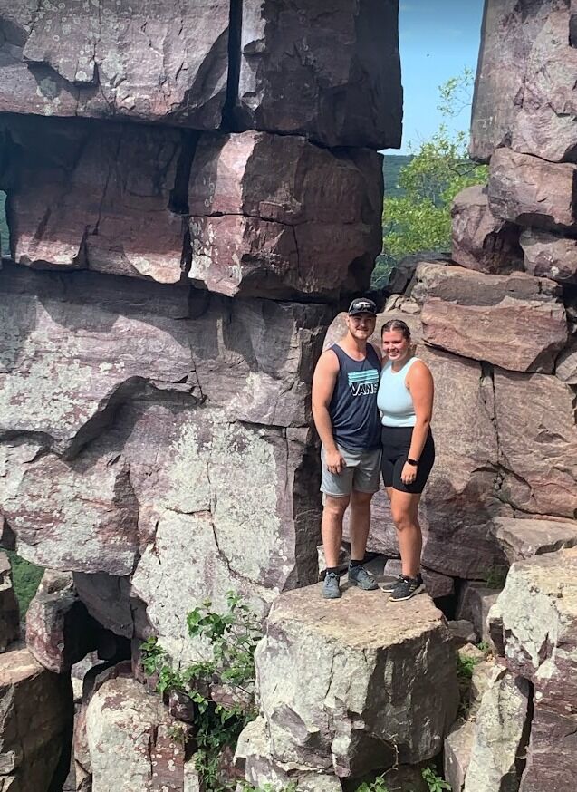 In search of a job, John moved to De Pere, Wisconsin in January of 2022. We met at the end of July in 2022 on Hinge, a dating app. After about a week after messaging, for our first date, we went to play volleyball. One of the local churches has open gyms on Tuesday nights. Ashlyn claims she didn’t believe that Johnathan was a murderer since he invited her to church. We were able to meet each other and get comfortable in a group setting. We didn’t really have a chance to talk while playing, but had fun playing on the same team and against each other. Ashlyn said one of her bucket list items for the summer was to go hiking at Devil’s Lake State Park. So, for our second date, we went and picked up coffee around 6:30 am and drove to Devil’s Lake. We did some hiking and swimming. On our way back the conversation continued, and we decided to stop for dinner. Ashlyn didn’t have the urge to ditch John, I guess he wasn’t a murderer after all. The next week John asked Ashlyn to be his girlfriend after a walk in De Pere. We both loved being around each other and always had fun.