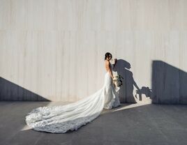 Bride wears an elegant wedding dress with a long train. 