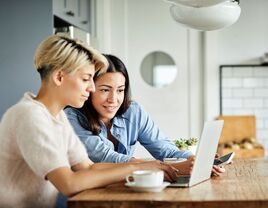 Couple planning their wedding on laptop