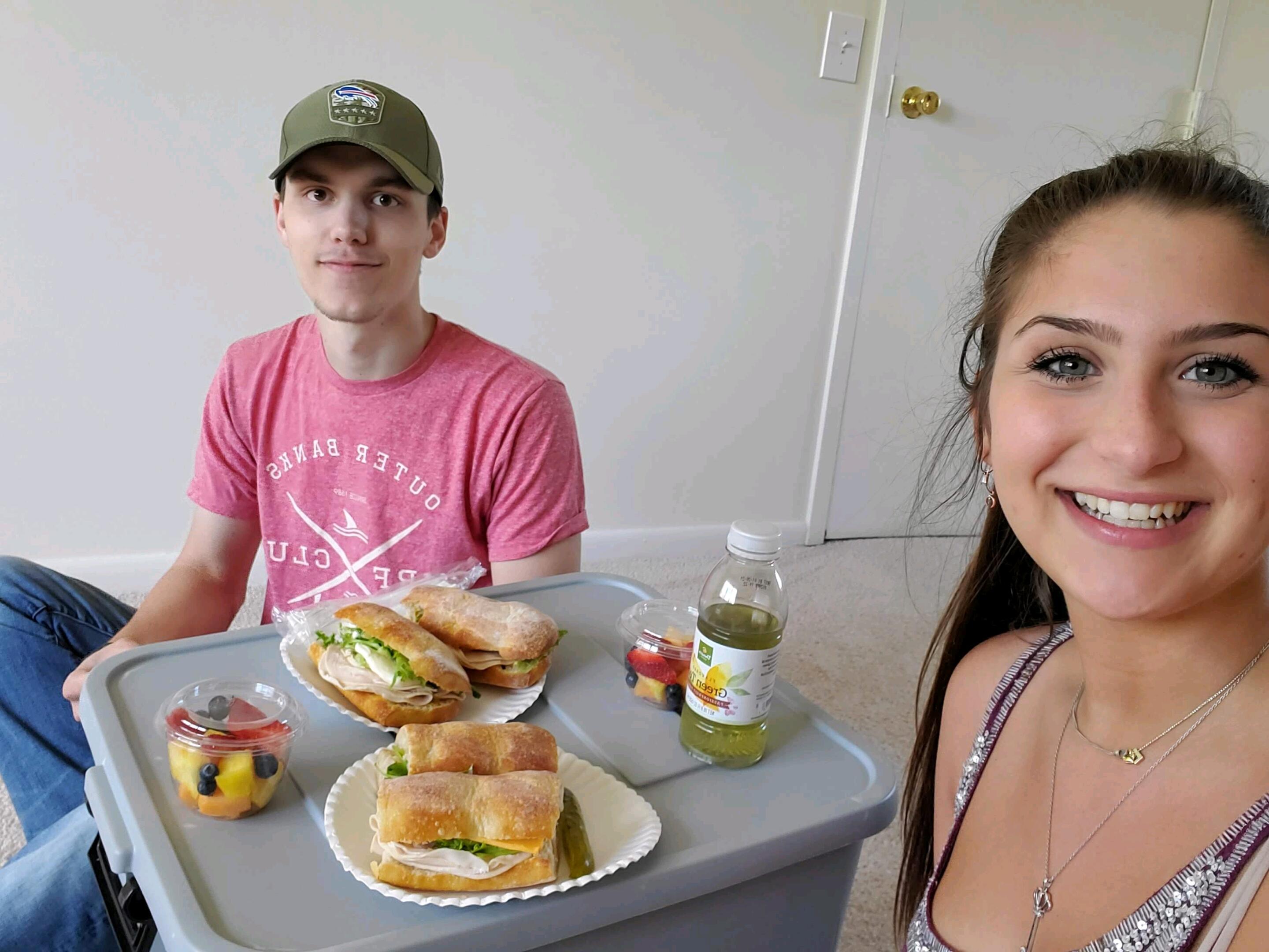 COVID-19 forced Leeann out of her dorm and back into her parents' house in March of her freshman year. Later that summer, Ryan and Leeann moved into their apartment in Henrietta to be closer to RIT. This picture was their first day in their new apartment, eating lunch on the floor with a storage tote as their table because they didn't have any furniture!