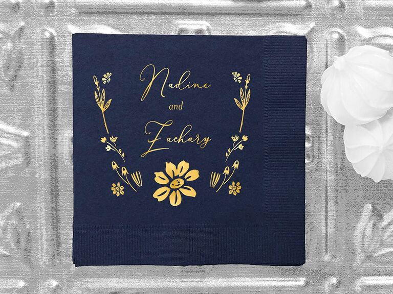 Navy napkin with names and elegant floral design in gold foil type