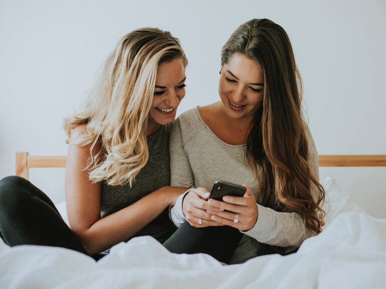 Brides smiling while looking at cell phone