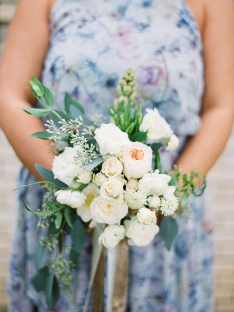 This burgeoning bouquet is simply one of a kind, with pale pastels and delicate greenery.