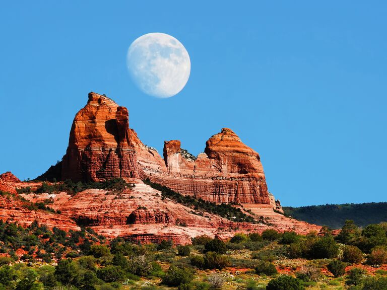 Moon over Red Rock country mountains surrounding Sedona Arizona