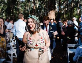 Happy guests walking down the aisle with a bottle of champagne