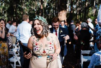 Happy guests walking down the aisle with a bottle of champagne