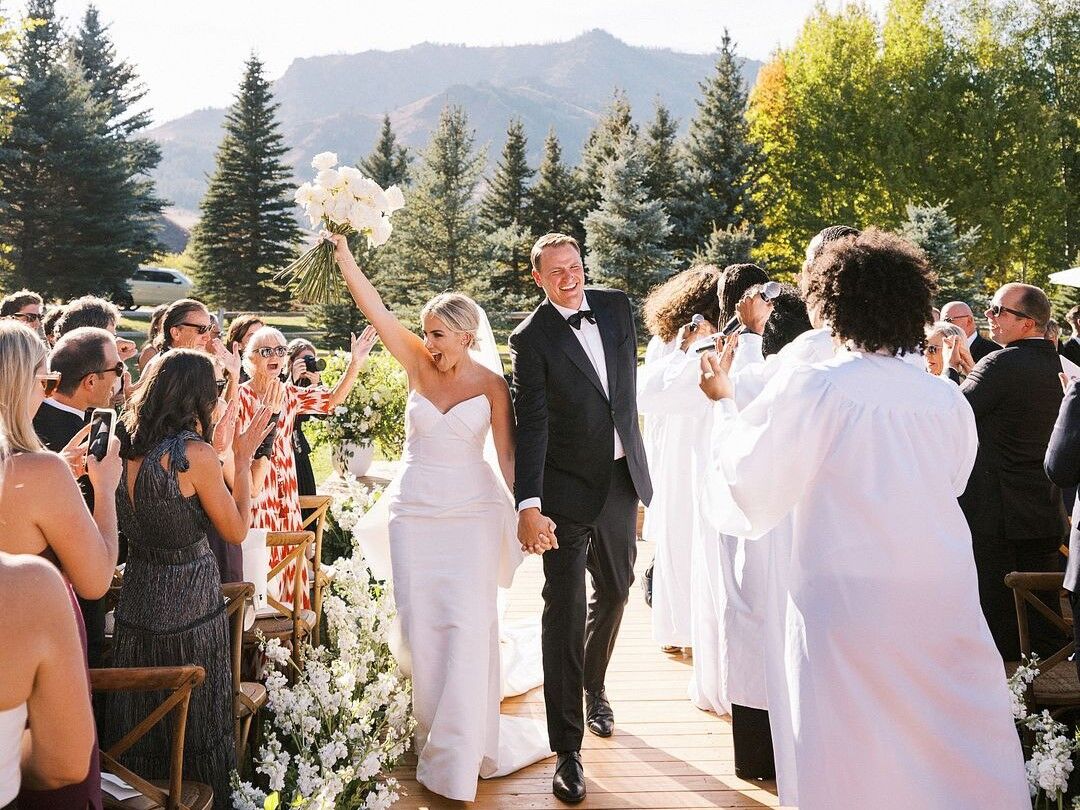 Couple celebrating while walking down the aisle after their ceremony