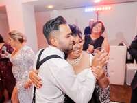 A groom with his mother dancing at the wedding