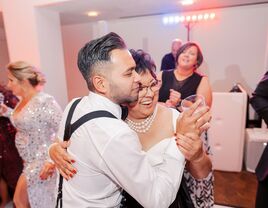 A groom with his mother dancing at the wedding