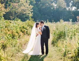 Bride with veil and groom in vineyard