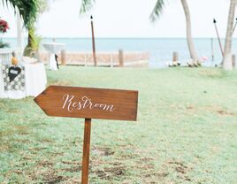 Restroom sign at wedding ceremony and reception.