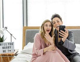 Couple taking selfie after getting engaged at home