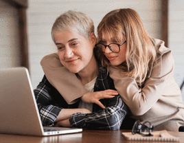 Couple using laptop at home