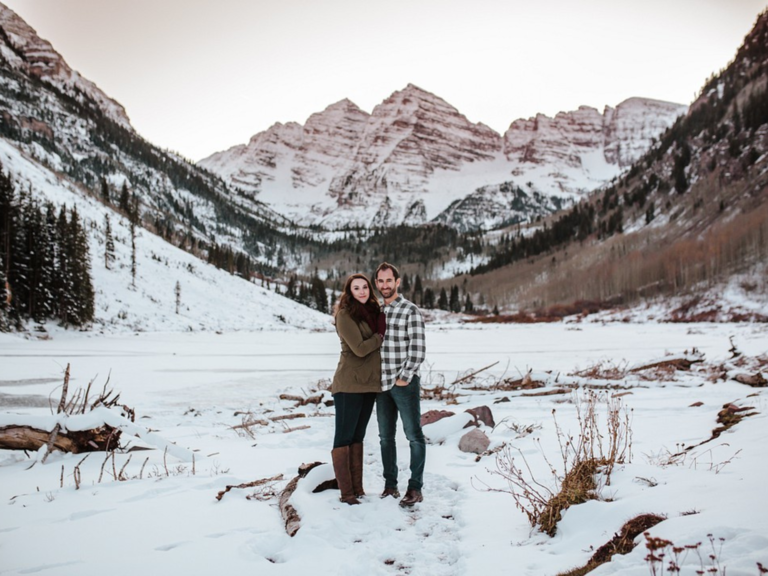 Couple posing with each other in snow in Colorado