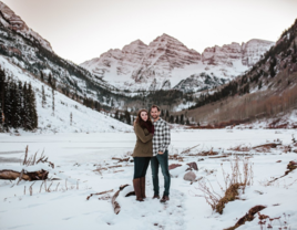 Couple posing with each other in snow in Colorado