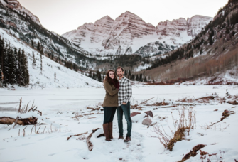 Couple posing with each other in snow in Colorado