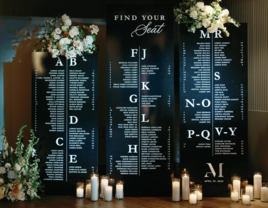 Elegant Black-and-White Seating Chart With Floral Arrangements and Candles