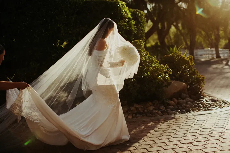 Bride wearing wedding dress with train and veil