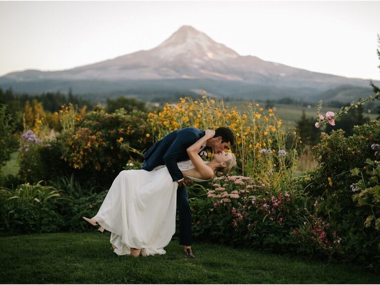 Couple doing a kissing pose in front of a beautiful backdrop