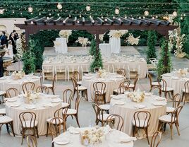 arial view of outdoor wedding reception, with round banquet tables and bentwood chairs