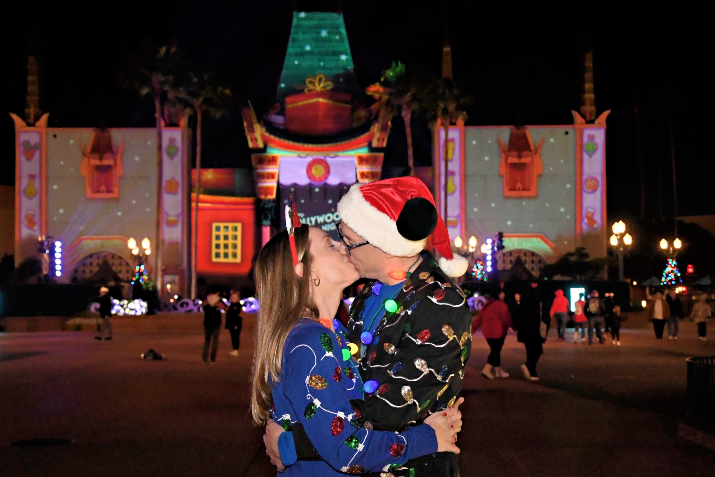 The Disney Christmas magic continues as Kirsten and Tyler attend Jollywood Nights, the big Christmas party event at Hollywood Studios. Their outfits are coordinating (featuring a sequined Christmas lights pattern on Kirsten's sweater and Tyler's blazer) rather than directly matching, but they still get lots of compliments and have fun taking cheesy photos together.