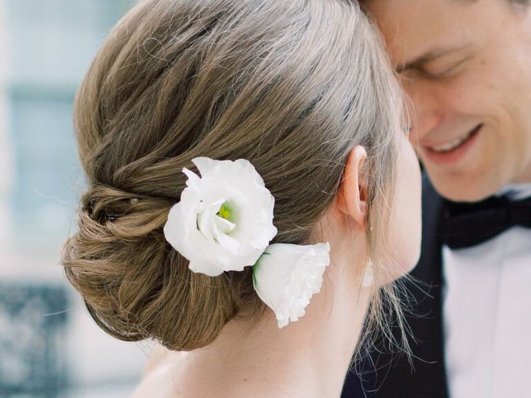 bridal updo with fresh white lisianthus blooms