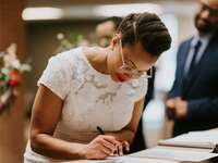 Bride signs a marriage license.