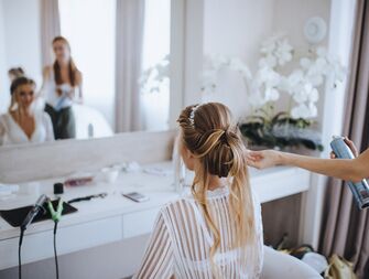Bride getting her hair styled