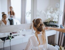 Bride getting her hair styled