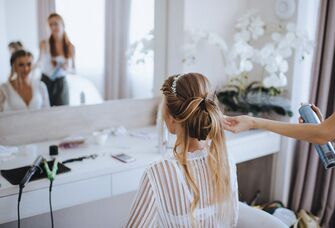 Bride getting her hair styled